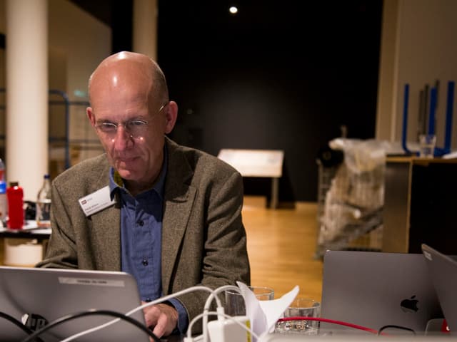 Mann sitz vor Laptop