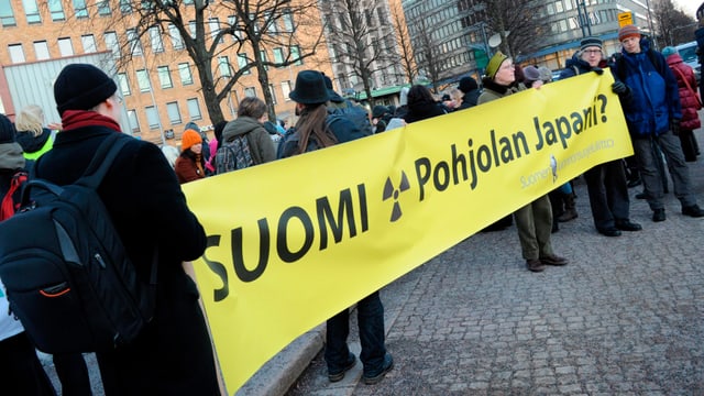 Menschen halten ein Banner hoch. Menschen halten ein Banner hoch.