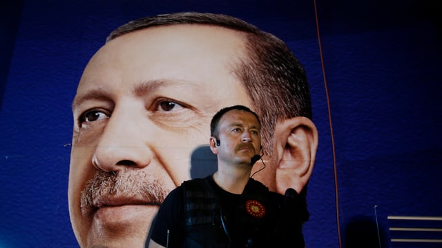 Sicherheitsbeamter vor einem Poster von Erdogan Sicherheitsbeamter vor einem Poster von Erdogan