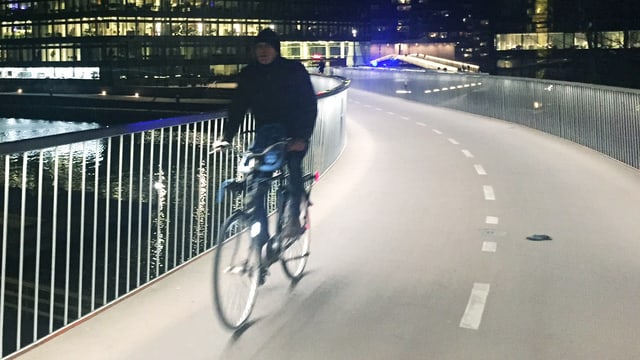Velofahrer fährt nachts aif einer beleuchteten Velospur. Velofahrer fährt nachts aif einer beleuchteten Velospur.