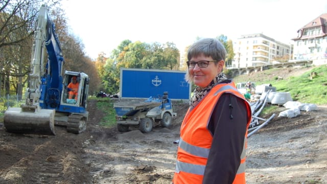 Frau in oranger Warnweste auf einer Baustelle. Frau in oranger Warnweste auf einer Baustelle.