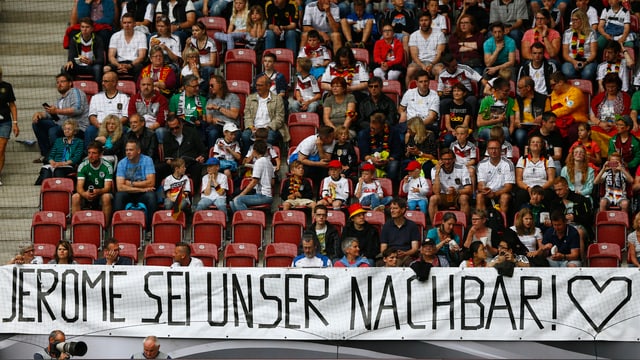 Fans auf einer Tribüne halten ein Banner auf dem steht: "Jérôme sei unser Nachbar!" Fans auf einer Tribüne halten ein Banner auf dem steht: "Jérôme sei unser Nachbar!"