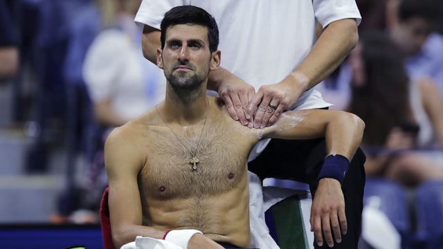 Purtret da Djokovic che sesa e lascha far massascha vi da sia spatla sanestra. Purtret da Djokovic che sesa e lascha far massascha vi da sia spatla sanestra.