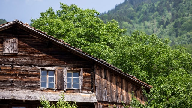 Kleine Fenster, dunkles Holz: Das rund 700-jährige Holzhaus an der Lauigasse in Steinen mit Bäumen im Hintergrund. Kleine Fenster, dunkles Holz: Das rund 700-jährige Holzhaus an der Lauigasse in Steinen mit Bäumen im Hintergrund.