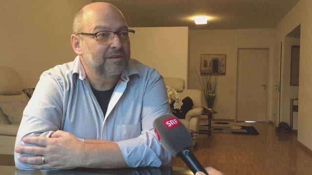 Ein Mann sitzt an einem Tisch. Ein Mann sitzt an einem Tisch.