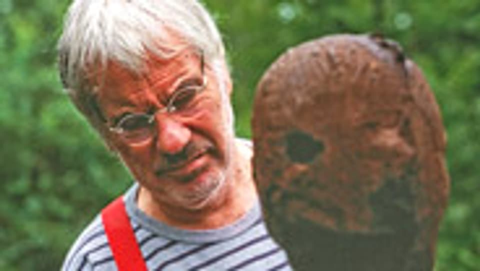 Schang Hutter betrachtet eine seiner Skulpturen (2002).