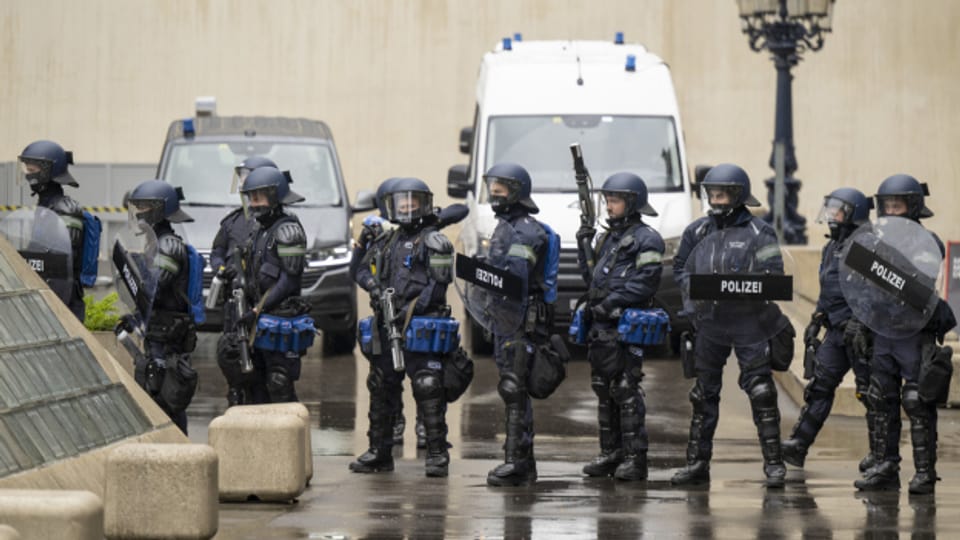 Ein Gruppe von Polizisten in Vollmontur steht in Basel auf der Strasse.