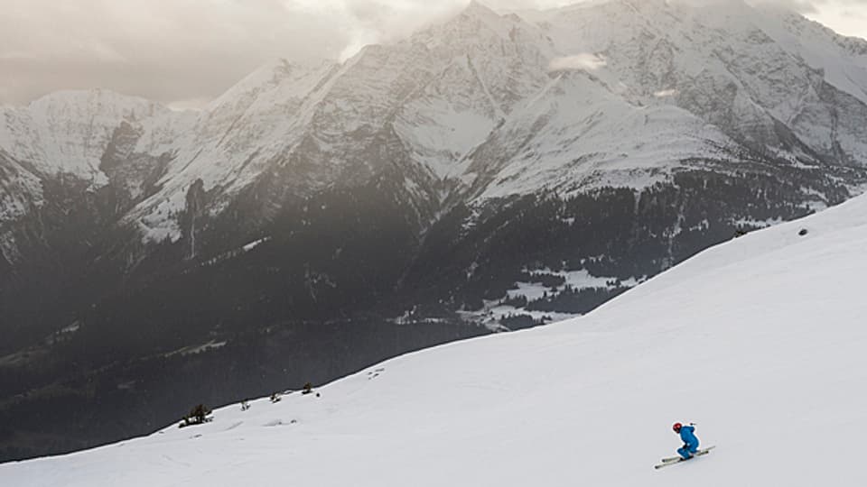 Ein Wintersportler in der Abfahrt vom Crap Sogn Gion nach Plaun am 15. Dezember 2014.