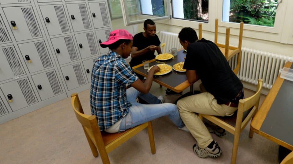 Asylsuchende beim Essen in einer Unterkunft.
