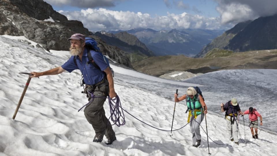 Seilschaft und ihr Bergführer unterwegs auf dem Silvrettagletscher.