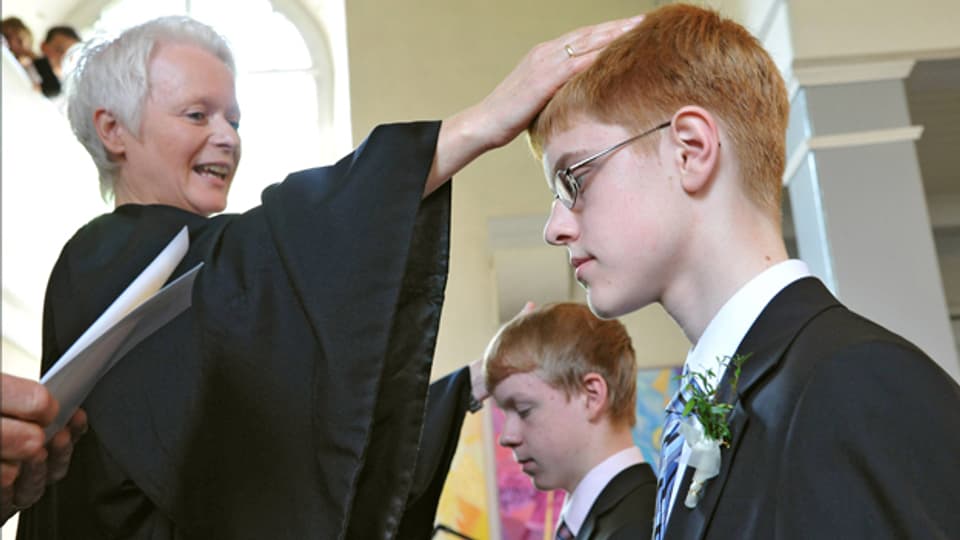 Die Pfarrerin Susanne Briese konfimiert einen Jungen in der Wunstorf-Luthe Kirche bei Hannover, 2012