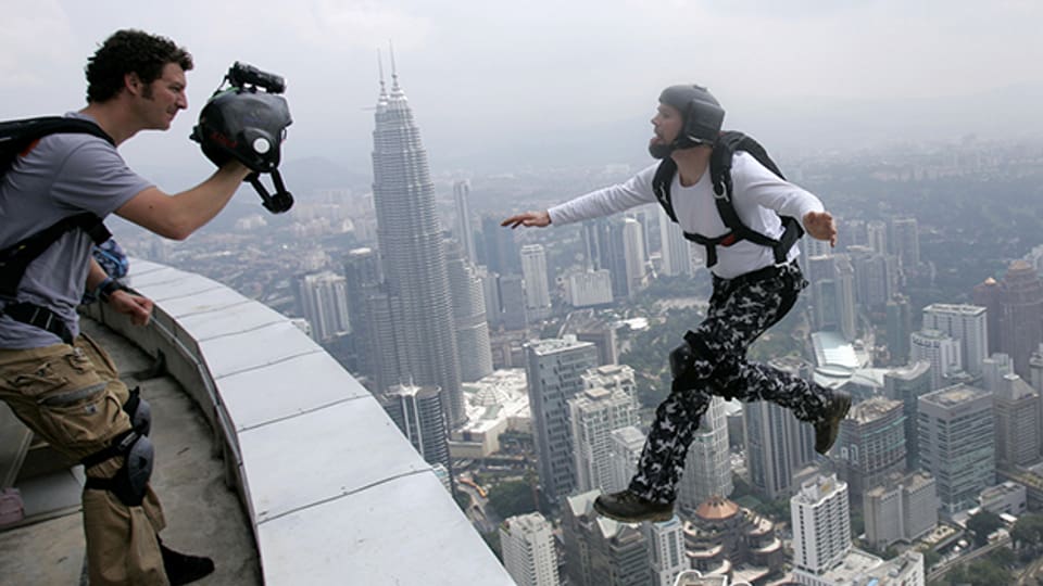Auf der Suche nach dem Kick und öffentlicher Aufmerksamkeit: Base-Jumper springt vom 421 Meter hohen Tower in Malaysia.