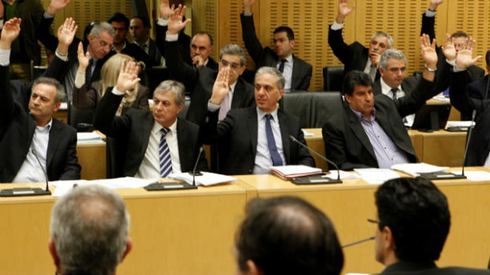 Zähneknirschend stimmt das zyprische Parlament für den Rettungsplan.