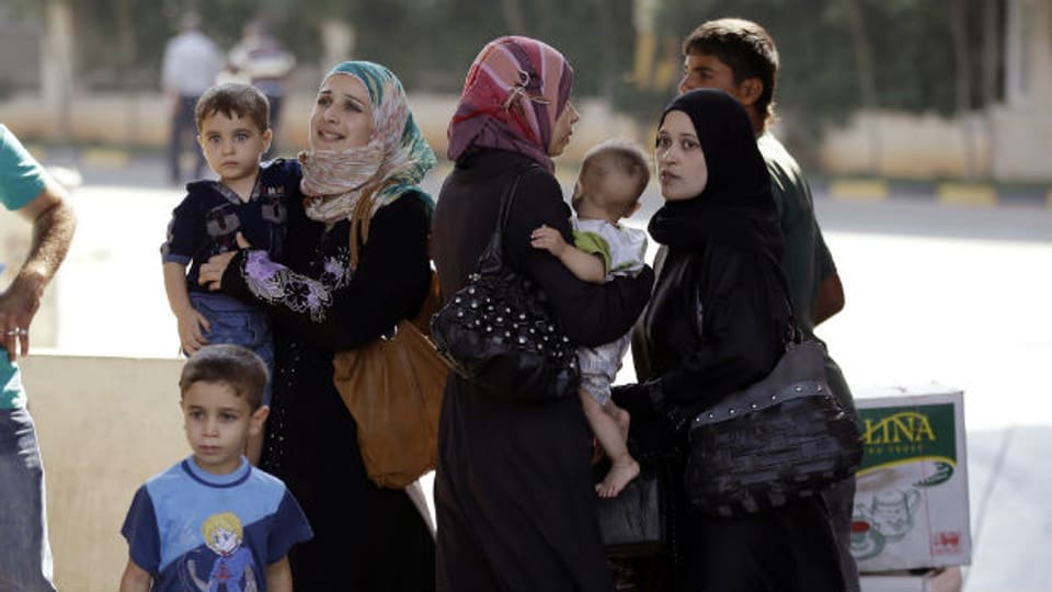 Flucht geglückt: Syrerinnen und Syrer an der türkischen Grenze (30.8.2013)