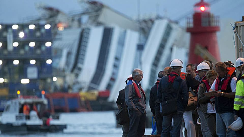 Arbeiter stehen auf der Insel Giglio zu ihrem Einsatz bereit: Die «Costa Concordia» soll aufgerichtet werden.