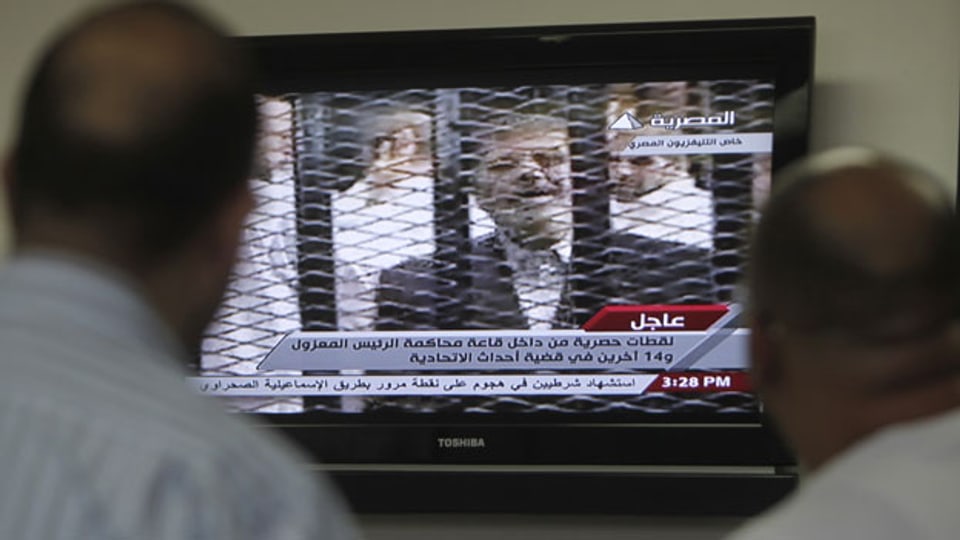 Ägypter verfolgen am Fernsehen den Prozess gegen den gestürzten ägyptischen Präsidenten Mohamed Mursi in Kairo am 4. November 2013
