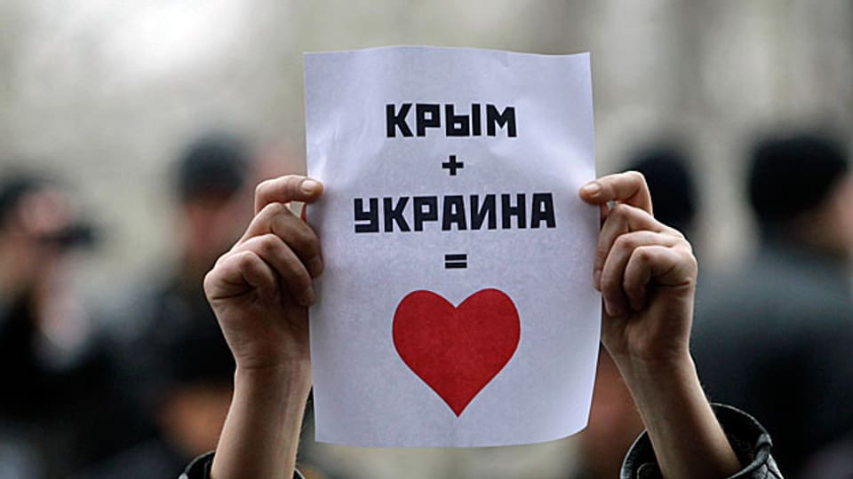 «Die Krim + die Ukraine = ein Herz» steht auf dem Plakat einer Demonstrantin in Simferopol auf der Krim.