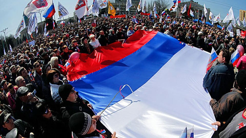 Pro-russische Aktivisten mit einer russischen Riesenflagge vor der ukrainischen Verwaltung in Donezk.