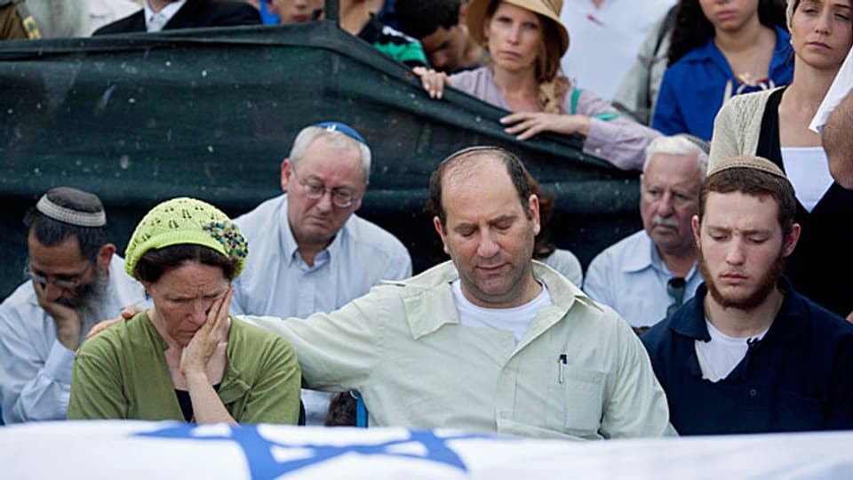 Angehörige der drei tot aufgefundenen jungen Israeli trauern in der Westbank. Die Särge sind in israelische Flaggen gehüllt.
