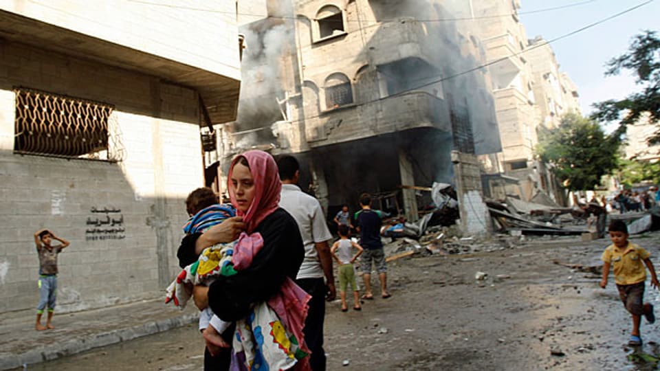 Eine palästinensische Mutter auf der Flucht - nach einem israelischen Bombeneinschlag in Gaza City.
