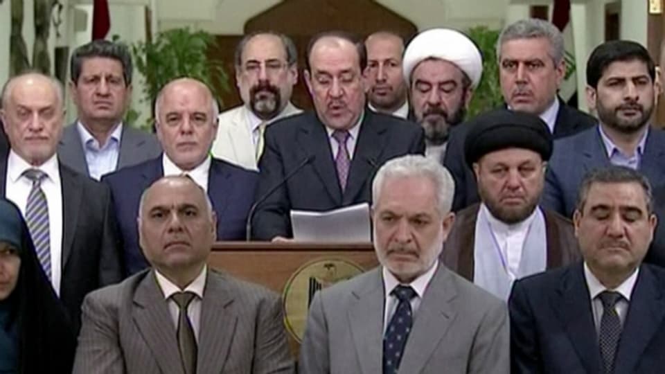 Nuri al-Maliki spricht an einem Podium, welches am irakischen TV übertragen wurde.