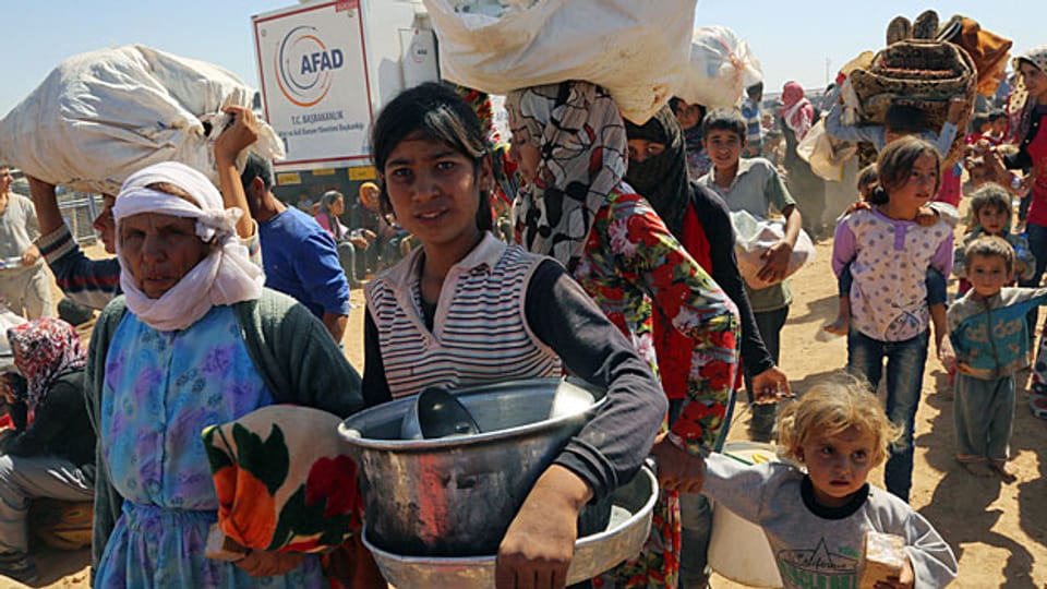 Tausende kurdische Flüchtlinge versuchen seit Tagen, bei Suruc über die Grenze und in die Türkei zu gelangen.