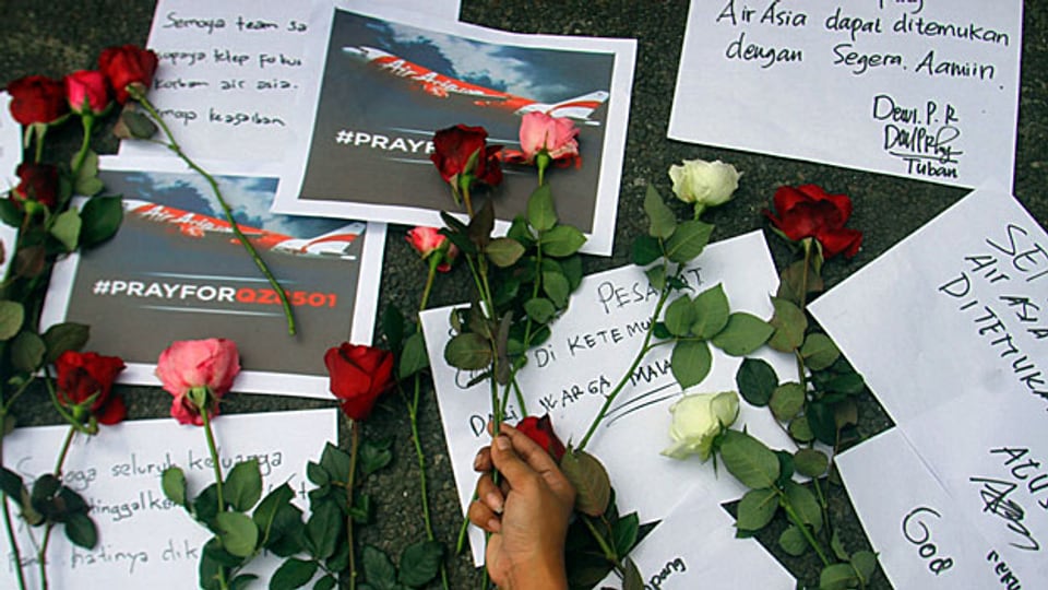 Blumen und Kondolenzbekundungen für die Passagiere der abgestürzten Air-Asia-Maschine; es scheint keine Überlebenden zu geben.