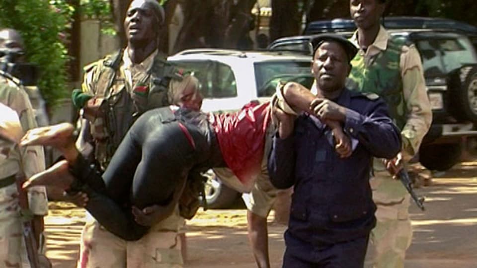 Eine verletzte Geisel wird von Sicherheitskräften aus dem Radisson Hotel, Bamako, Mali, getragen. Mindestens 170 Personen wurden als Geiseln festgehalten.
