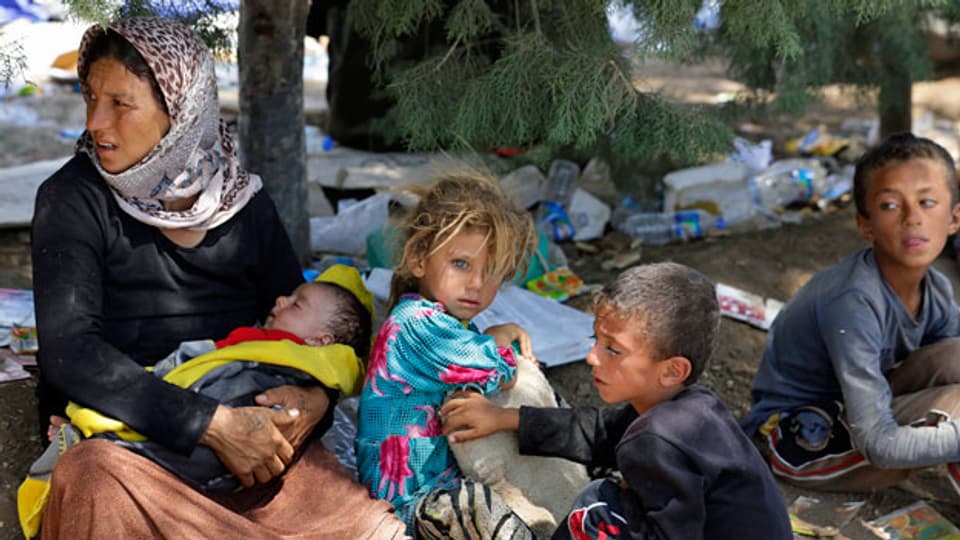 Eine Jesiden-Familie, aus der der irakischen Stadt Sinjar auf der Flucht. Aufnahme vom August 2014.