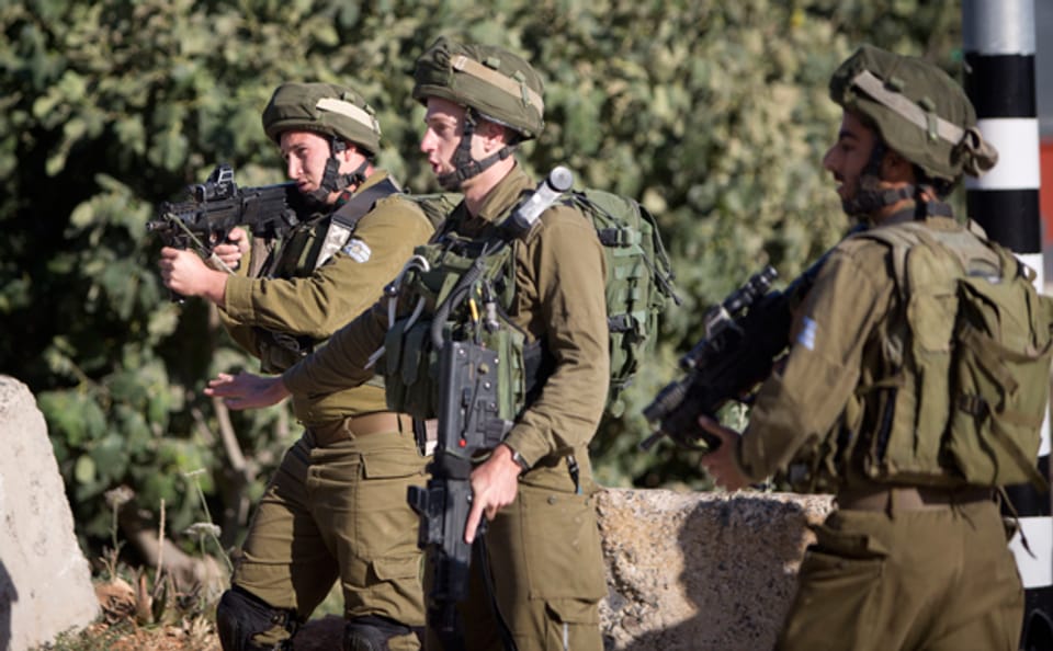 zwei israelische Soldaten bewachen einen Checkpoint im besetzten Westjordanland
