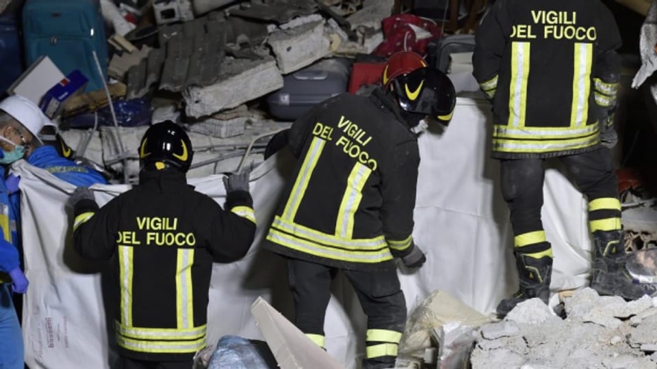Feuerwehrleute bergen im italienischen Amatrice ein Todesopfer.