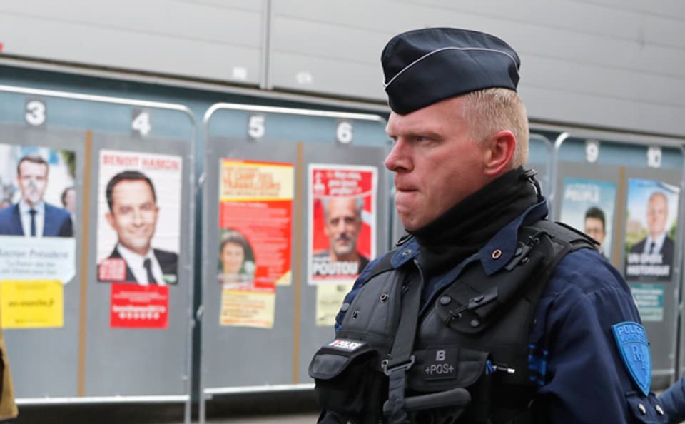 Ein Polizeioffizier bewacht ein Wahllokal in der nordfranzöischen Stadt Heinin-Beaumont.