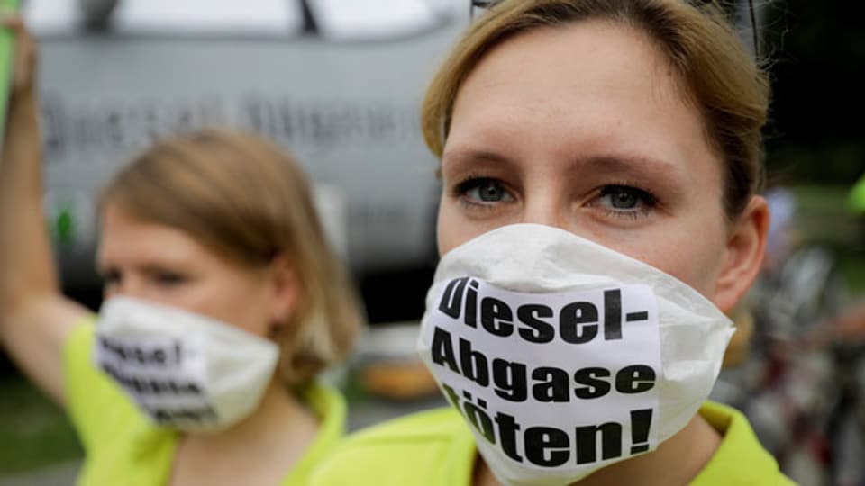 Diesel sollen mit neuer Software sauberer werden. Bild: Demonstrantin gegen Dieselfahrzeuge.
