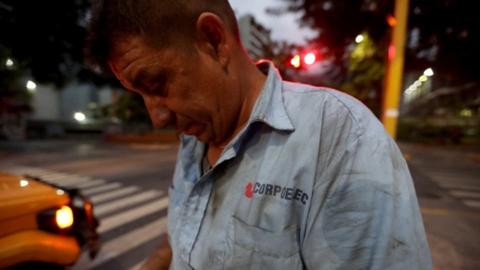 Ein Mitarbeiter der Elektrizitätswerke arbeitet an Stromleitungen in Caracas.