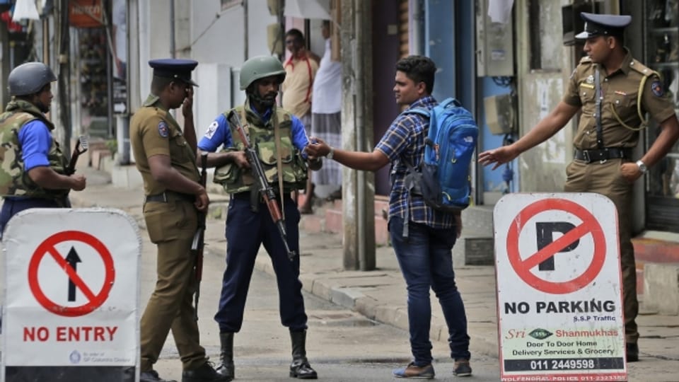 In Sri Lanka führen Sicherheitskräfte Personenkontrollen durch.