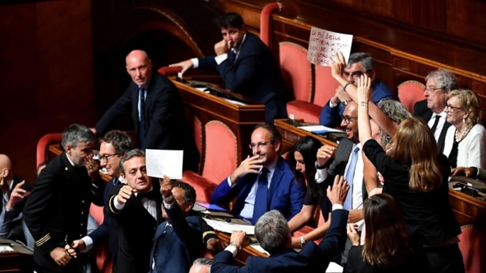 Steit im italienischen Parlament ist keine Seltenheit. Hier zeigen Abgeordnete der demokratischen Partei ihren Protest während der Debatte zur aktuellen Regierungskrise.