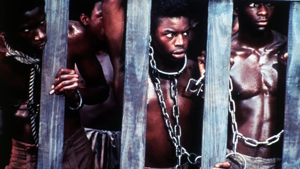 Symbolbild. Afrikanische Sklaven hinter Gittern.