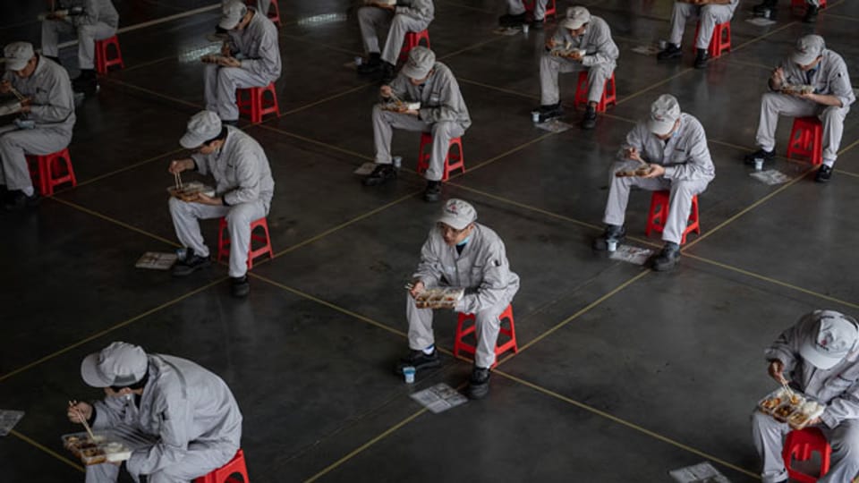 Arbeiter in der Mittagspause mit  1,5 Meter Abstand in Wuhan, Provinz Hubei, am 23. März 2020.