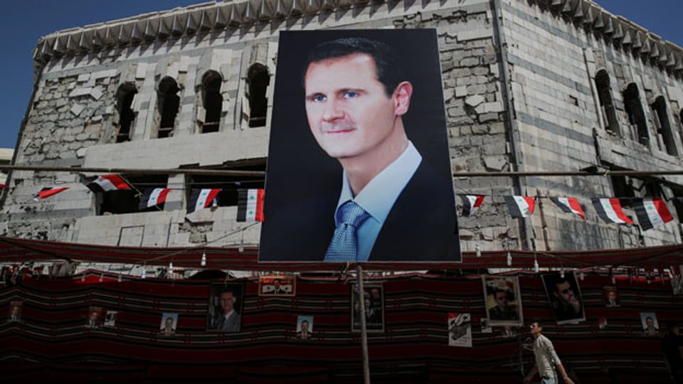 Banner des syrischen Präsidenten Bashar al-Assad an einem Gebäude in Douma, aussererhalb von Damaskus, Syrien.