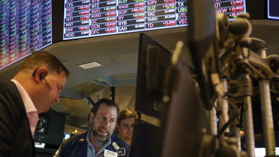 Lange Gesichter an der Wall Street in New York. Die Aktienkurse befinden sich weltweit auf Talfahrt.