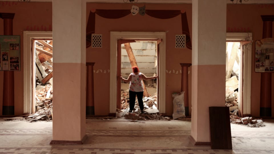 Eine Frau betrachtet die Trümmer am Eingang des «Hauses der Kultur» in Chuhuiv, in der Region Charkiw.