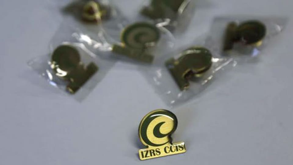 Pin mit dem Logo des Islamischen Zentralrates Schweiz.