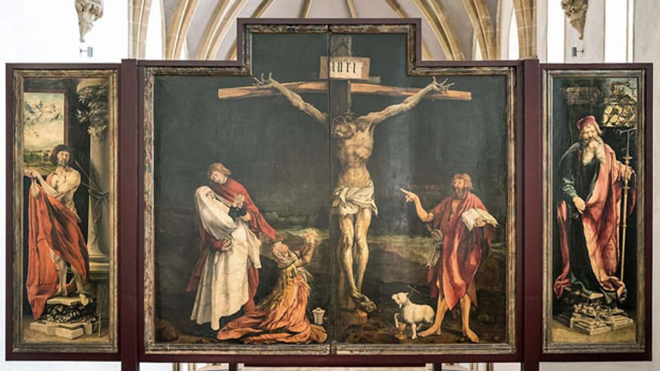 Isenheimer Altar in Colmar. Das erste Wandelbild mit der Kreuzigungstafel, flankiert von dem Märtyrer Sebastian (li) und dem Einsiedler Antonius.