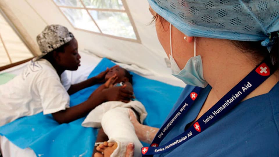 Symbolbild. Eine Ärztin kümmert sich um ein Kind in Haiti.