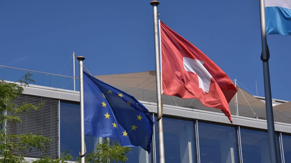 Die Schweizer Fahne und die EU-Fahne.