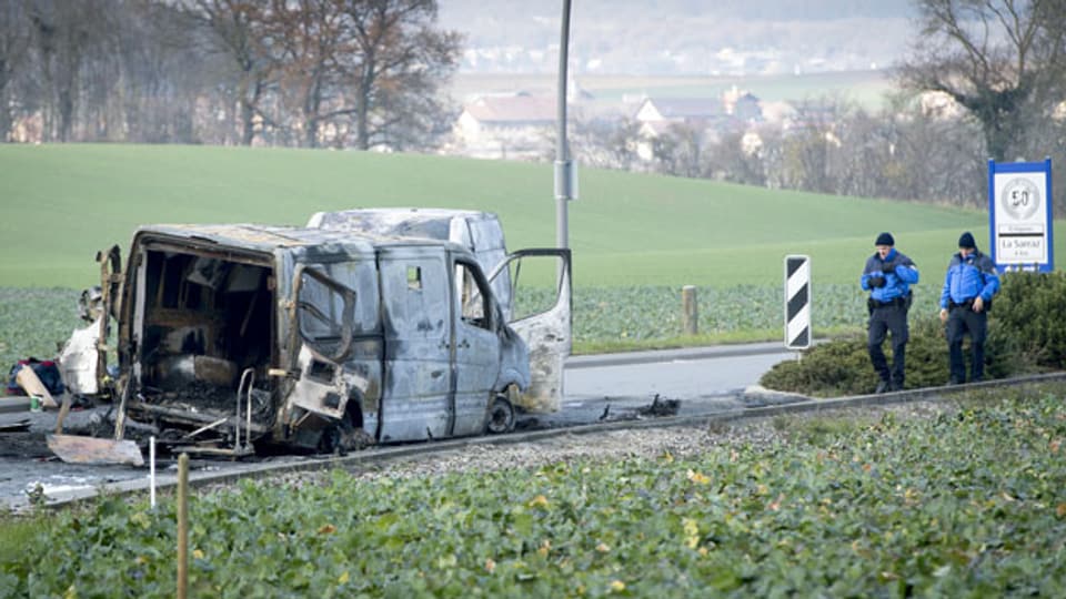 Nach einem Überfall: Verkohlter Geldtransporter am Ortsausgang in Daillens, Kanton Waadt.
