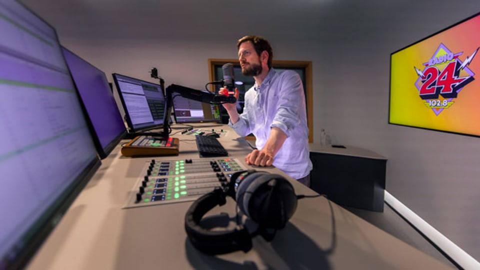Dominik Widmer moderiert eine Sendung im Radiostudio von Radio 24.