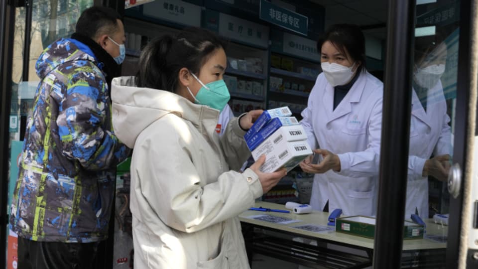 Eine Anwohnerin deckt sich in Peking mit Medikamenten ein.