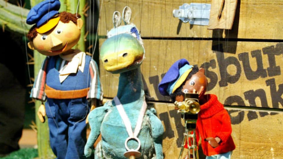 Prominente Figuren aus der Augsburger Puppenkiste: Lukas, der Lokführer; das Urmel und Jim Knopf.