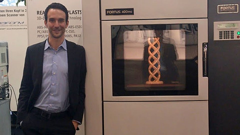 Matthias Baldinger steht vor einem 3D-Drucker.
